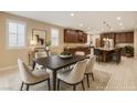 Elegant dining area featuring a table for six and an open-concept design connecting to the kitchen at 1004 Bluebird Ridge Ct, North Las Vegas, NV 89084