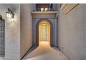 Inviting front door with arched entryway, recessed lighting, and textured walls at 1004 Bluebird Ridge Ct, North Las Vegas, NV 89084