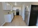 Functional kitchen featuring white cabinets, tile floors, and stainless steel appliances at 1016 Vantage Point Rd, Las Vegas, NV 89128