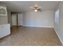 Spacious living room with neutral paint, tile flooring, and a modern ceiling fan fixture at 1016 Vantage Point Rd, Las Vegas, NV 89128