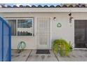 Close up of front entrance, featuring security door, leafy plant, and house number at 2040 Willowbury Dr # A, Las Vegas, NV 89108