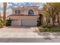 Charming two-story home featuring a three-car garage, landscaped yard, and a red tile roof at 21 Ocean Harbour Ln, Las Vegas, NV 89148