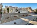 A beautiful single-story house featuring desert landscaping, a tile roof, and an attached three-car garage at 2221 Loggerhead Rd, Las Vegas, NV 89117