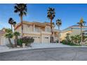 Beautiful home showcasing a spacious three-car garage, meticulous landscaping, and a grand entrance at 2705 Crystal Beach Dr, Las Vegas, NV 89128