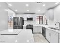 Modern kitchen with white cabinets, stainless steel appliances, and quartz countertops at 3975 Saddlewood Ct, Las Vegas, NV 89121
