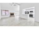 Bright living room with tile floors, a brick fireplace, and a kitchen view at 3975 Saddlewood Ct, Las Vegas, NV 89121