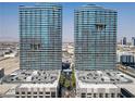 Stunning view of symmetrical high-rise condo buildings, presenting a sleek and modern facade with ample parking at 4575 Dean Martin Dr # 1811, Las Vegas, NV 89103