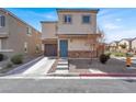 Charming two-story home with a welcoming blue door and low maintenance front yard at 4941 Quest Tribe St, Las Vegas, NV 89122