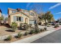 Attractive two-story residence with an attached two-car garage, complimented by neat landscaping and green lawn at 5652 Nobleton Ct, North Las Vegas, NV 89081