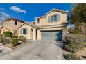 Inviting two-story home with a two-car garage and neat landscaping, set against a clear blue sky at 5652 Nobleton Ct, North Las Vegas, NV 89081