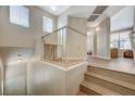 Landing featuring wood floors, white railings, and views into the living room and toward the front door at 5855 Valley Dr # 2108, North Las Vegas, NV 89031