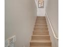 A bright staircase with light wood steps and white handrail ascends to the upper level of the home at 5855 Valley Dr # 2108, North Las Vegas, NV 89031