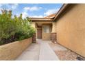 Charming home entryway with stone pillars and pathway leading to the front door at 6138 Equine Ave, Las Vegas, NV 89122