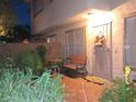 Charming outdoor patio with seating, lush plants, and secure gated entryway, ideal for relaxing evenings at 6412 Big Pine Way, Las Vegas, NV 89108