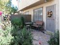 Private patio with lush greenery, seating area, and secure gated entryway, perfect for outdoor relaxation at 6412 Big Pine Way, Las Vegas, NV 89108