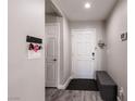 Clean foyer with a bench, decorative hooks, and a stylish, neutral color scheme at 652 Carlos Julio Ave, North Las Vegas, NV 89031