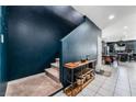Entryway with blue wall, staircase and open floor plan leading to kitchen and dining at 7138 Superstar St, North Las Vegas, NV 89084