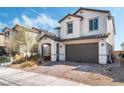 Charming two-story home featuring a two-car garage, landscaped front yard and a welcoming covered entry way at 7138 Superstar St, North Las Vegas, NV 89084