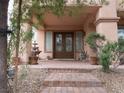 Inviting front entrance with double doors, stone pathway, and decorative fountain at 8070 Pavarotti Ave, Las Vegas, NV 89178