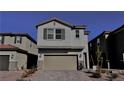 A charming two-story home featuring a two-car garage and beautiful, low-maintenance desert landscaping at 8974 Lucky Crest St, Las Vegas, NV 89113