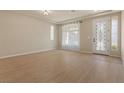Bright and airy living room with wood floors, recessed lighting, and neutral paint at 9853 Russian Hill St, Las Vegas, NV 89141