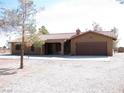Welcoming single-story residence boasting desert landscaping and a convenient two-car garage at 1081 Pluto St, Pahrump, NV 89048