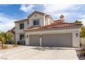 Charming two-story home featuring desert landscaping and a spacious three-car garage at 1600 Windsford Cir, Las Vegas, NV 89117