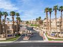 Gated condo community with lush landscaping, palm trees, and well-maintained streets at 2160 Highpointe Dr # 103, Laughlin, NV 89029