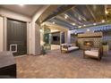 Relaxing outdoor space with brick flooring, pergola, string lights, and cozy seating area at 258 Castellari Dr, Las Vegas, NV 89138