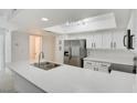 A bright kitchen featuring stainless steel appliances, white cabinets, and a skylight at 2716 Ferrin Rd, Las Vegas, NV 89117