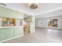 Bright, open-concept living room with light wood floors and a large window, seamlessly connecting to the kitchen at 3141 Pinehurst Dr # C, Las Vegas, NV 89109