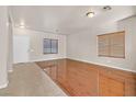 Open-concept living room filled with natural light showcasing beautiful hardwood floors and neutral paint at 33 Gentilly Lace Ave, Henderson, NV 89002