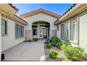 Welcoming front entrance with modern glass door and manicured landscaping at 33 Hassayampa Trl, Henderson, NV 89052