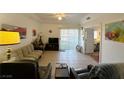 The spacious living room is well-lit, featuring neutral colors, tile floors, a ceiling fan, and easy balcony access at 3550 Bay Sands Dr # 1101, Laughlin, NV 89029