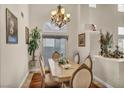 Formal dining room with natural light, elegant chandelier, and space for entertaining at 3728 Russell Peterson Ct, Las Vegas, NV 89129