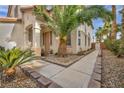 Landscaped front yard with walkway leading to the front door, accented with desert rock and various plants at 3728 Russell Peterson Ct, Las Vegas, NV 89129