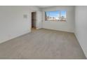 Bright bedroom with neutral carpet, a large window, and a closet for ample storage at 3759 Mckinley Cir, Las Vegas, NV 89121