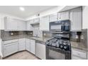 Well-designed kitchen with gray cabinetry, black appliances, and ample counter space at 3944 Visby Ln, Las Vegas, NV 89119