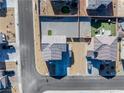 Aerial view of the property showcasing the landscaped yards, neighboring homes, and street access at 3981 E Teller Dr, Pahrump, NV 89061