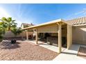 Backyard featuring a covered patio, outdoor furniture, hot tub, and desert landscaping at 455 Paulson Dr, Las Vegas, NV 89123