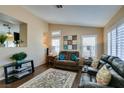 Cozy living room with wood floors, plantation shutters, neutral walls, and comfortable seating at 455 Paulson Dr, Las Vegas, NV 89123