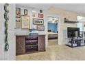 Welcoming interior with a modern wood console, stylish decorations, and a glimpse into a cozy bedroom at 6680 Abruzzi Dr # 102, North Las Vegas, NV 89084
