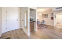 Inviting entryway featuring a wet bar, a modern light fixture, and a view into the dining area at 725 N Royal Crest Cir # 227, Las Vegas, NV 89169