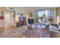 Cozy living room with a fireplace, comfortable seating, and a sliding glass door to a balcony at 725 N Royal Crest Cir # 227, Las Vegas, NV 89169