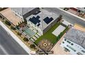 Backyard view featuring a pool, solar panels, a fire pit, and outdoor seating in a fenced yard at 7255 Bold Rock Ave, Las Vegas, NV 89113