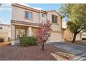 Inviting home featuring a two-car garage, well-manicured landscaping, and a welcoming entrance at 7925 Limbwood Ct, Las Vegas, NV 89131