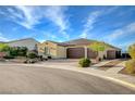 Well-maintained single-story home with a desert landscape, a three-car garage, and a neatly paved driveway at 8298 W Agate Ave, Las Vegas, NV 89113