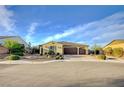 Attractive single-story home showcasing desert landscaping, a three-car garage, and a welcoming facade at 8298 W Agate Ave, Las Vegas, NV 89113