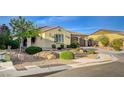 Charming single-story home boasts a well-manicured front yard with desert landscaping and a three car garage at 8298 W Agate Ave, Las Vegas, NV 89113
