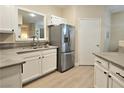 Well-lit kitchen with stainless steel refrigerator, modern countertops and white cabinetry at 9000 S Las Vegas Blvd # 1187, Las Vegas, NV 89123